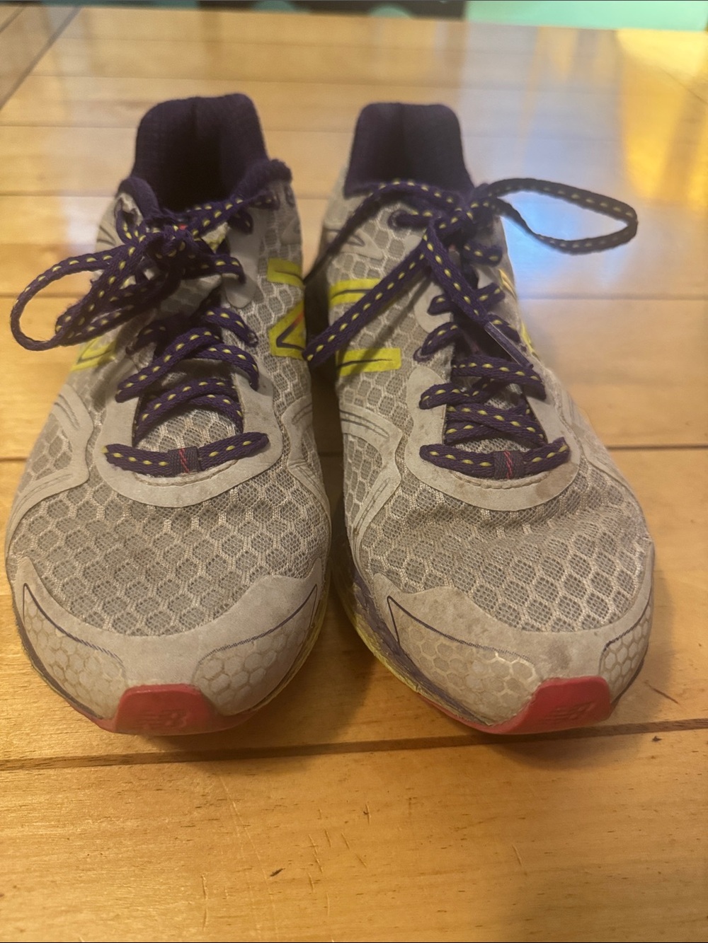 New Balance Gray Running Shoes with Purple Laces and Yellow Logo